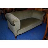 A green upholstered two seat sofa.