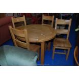 A 43" diameter circular kitchen table and four matching chairs.