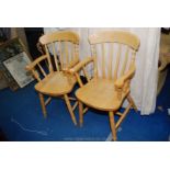 A pair of carver chairs.