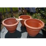 Three large terracotta garden planters, one a/f.