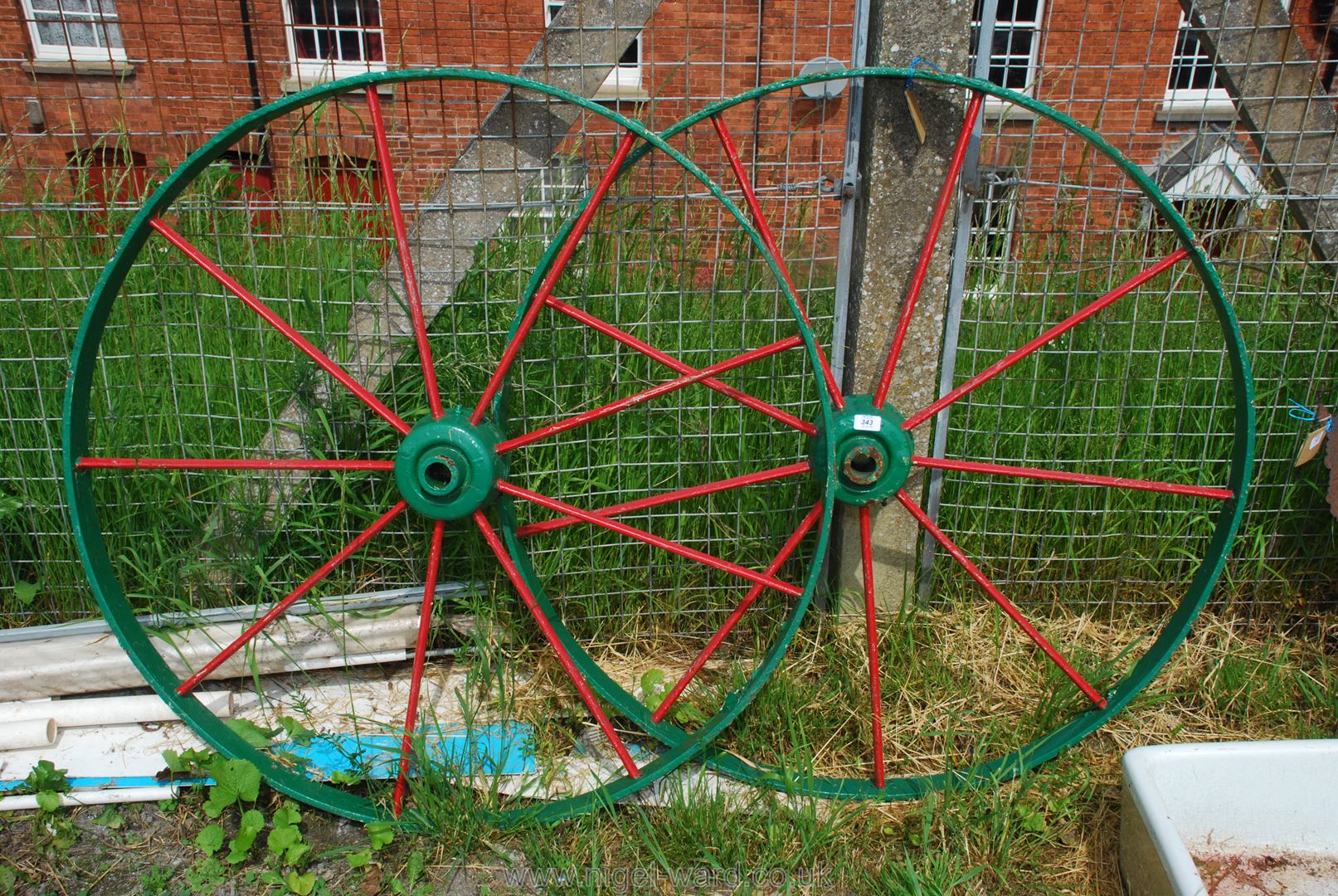 A painted pair of cast iron wagon Wheels, 43'' diameter.