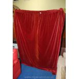 A quantity of red faded curtains.