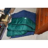 Two green sleeping bags.