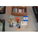 A box of novels and children's books.