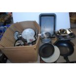 A box of kitchenware including a wok, roasting tin etc.