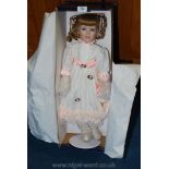 A boxed doll on a stand.
