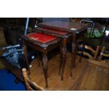 A nest of three glass topped tables.