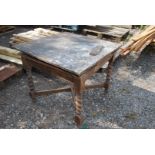 An oak dining table with barley twist legs for restoration.