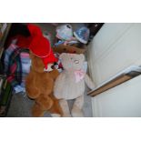 A trunk containing large teddies, picnic rug, Christmas stockings, lamp shades and hangers.