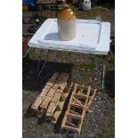 Five folding wooden wine racks, two folding camping tables and a stoneware cider flask.