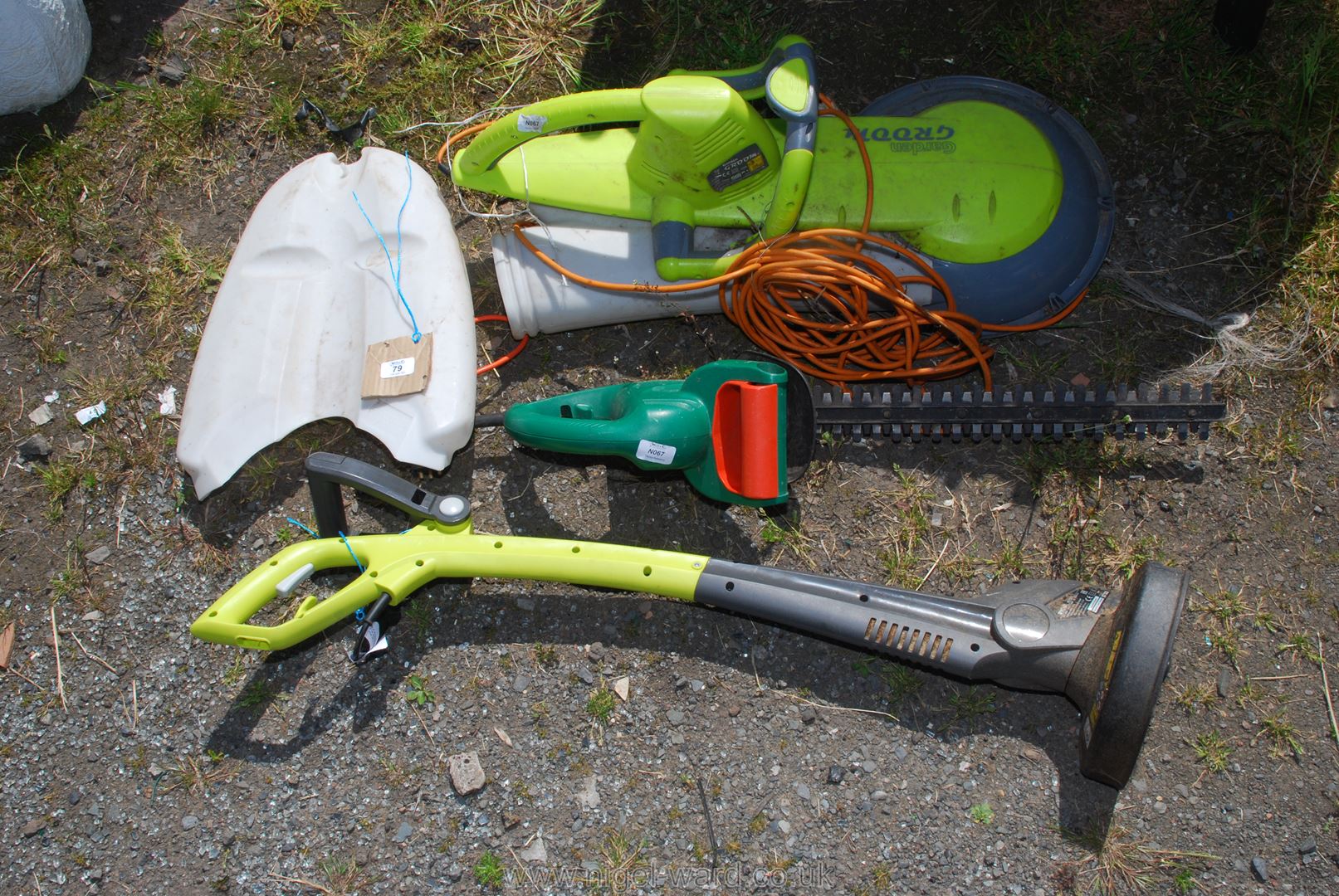 A garden strimmer and two hedge cutters.