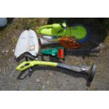 A garden strimmer and two hedge cutters.