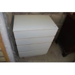 A white finished modern four drawer bedroom chest of drawers.