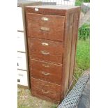 A wooden four drawer filing cabinet. 20" wide x 51" high x 25" deep.