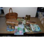 A quantity of cooking books, brass shells, new kitchen knives, wicker shopping basket etc.