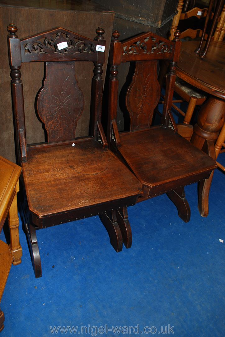 A similar pair of hall chairs.