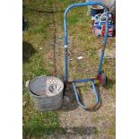 A galvanised mop bucket and a trolley sack truck.