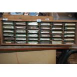 A shelf unit containing 30 tins of various screws and fixings.