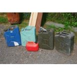 Four military jerry cans dated 1944, 1950, 1952 and 1953 and a petrol can.