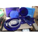 A quantity of large blue various shaped platters.