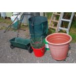 A seed spreader, large plastic planter on wheels, pop-up garden trug, hanging baskets, etc.