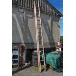 A sixteen rung single extension wooden Ladder.