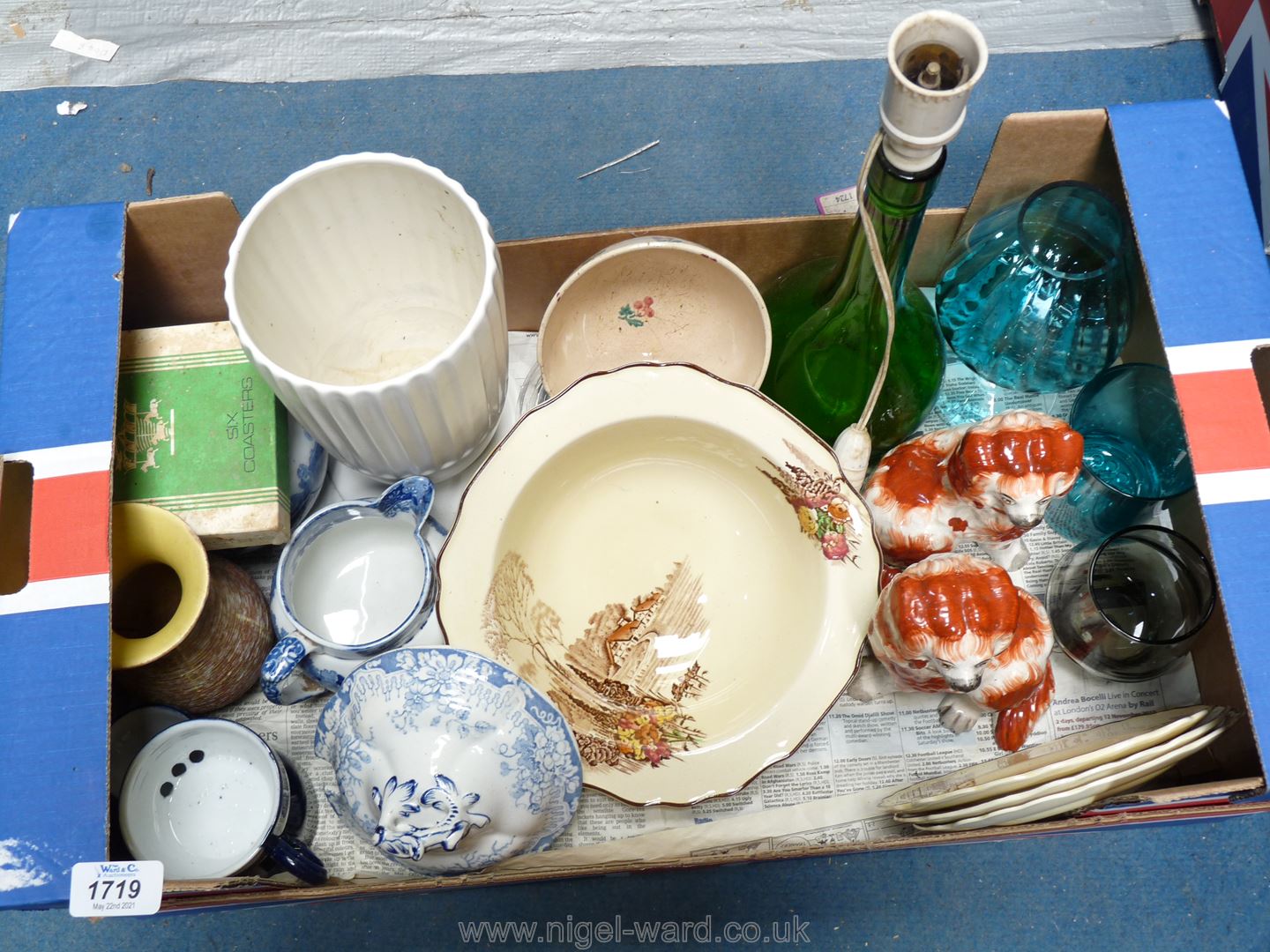 A box of china including blue and white jugs, pair of Staffordshire mantle Spaniels,