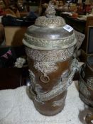 A large Tibetan brass and copper ceremonial canister with brass dragon wrapped around the outside