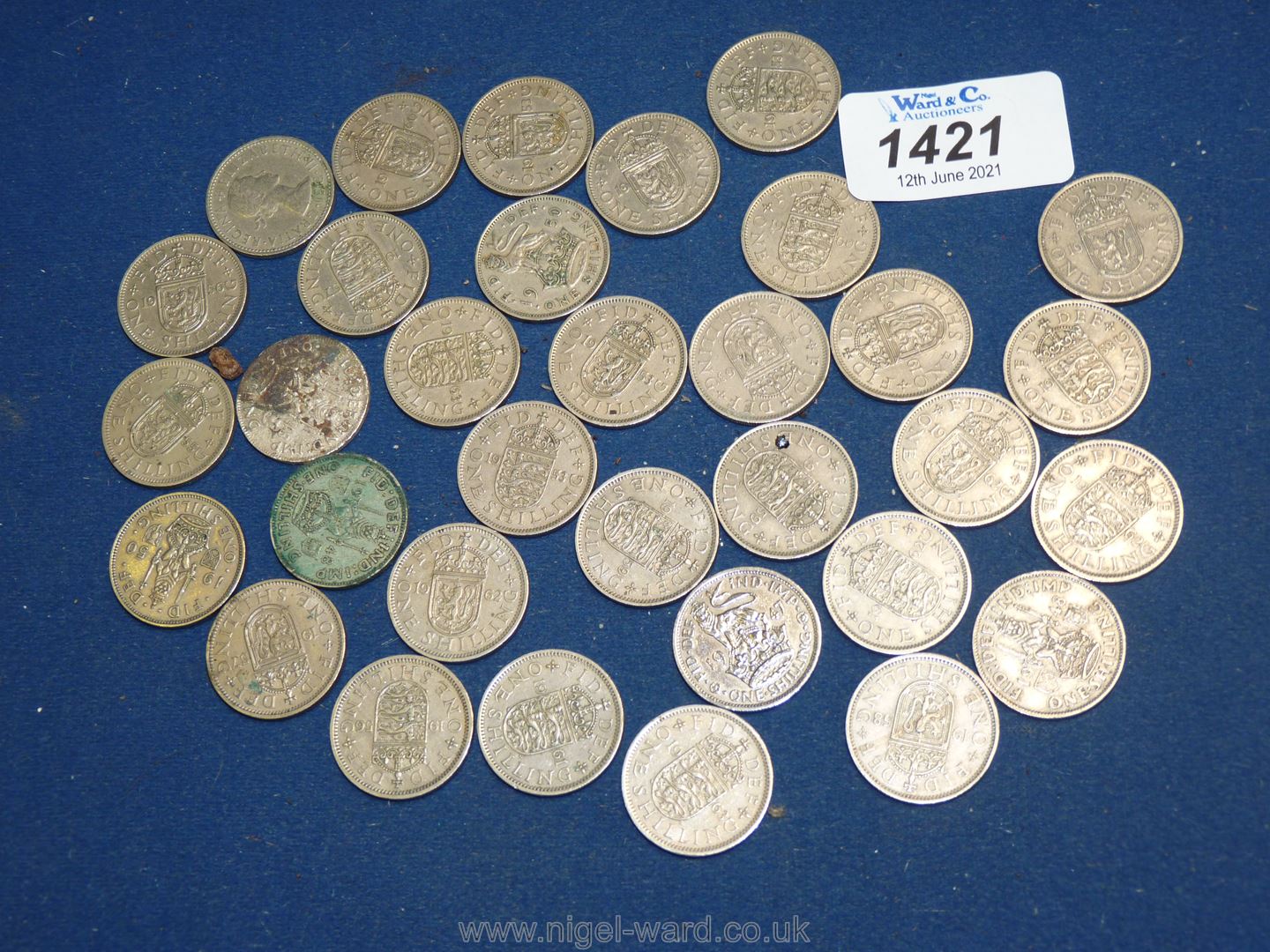 A quantity of George VI and Queen Elizabeth II shillings 33/- worth in total.
