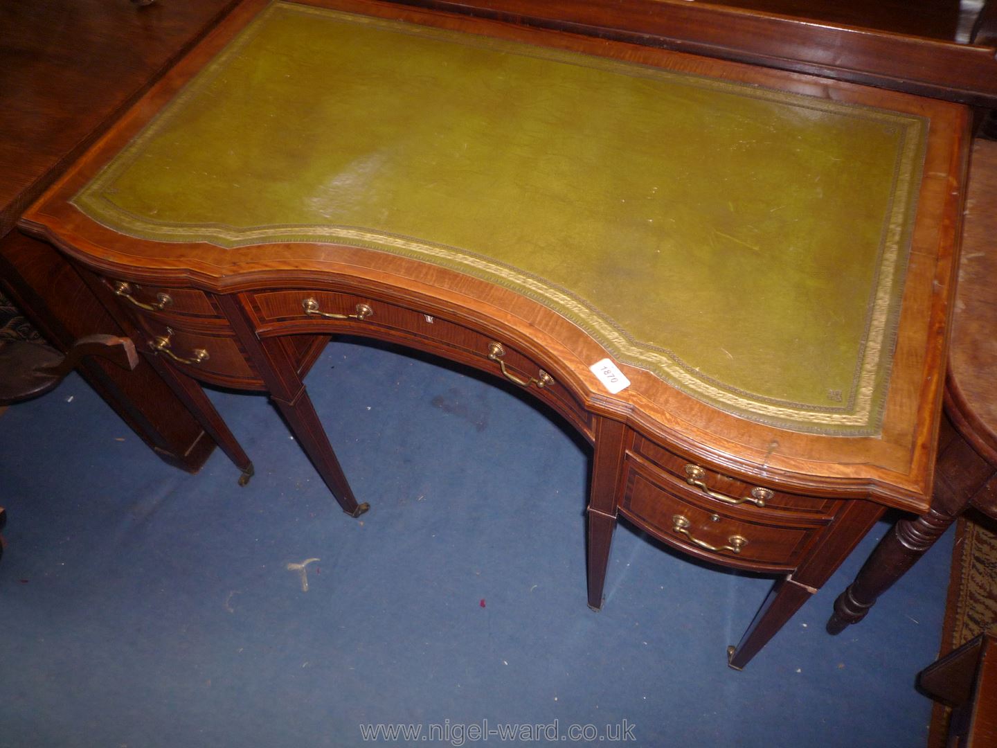 A lovely circa 1900 serpentine fronted Writing Table in Mahogany and other wood with light and