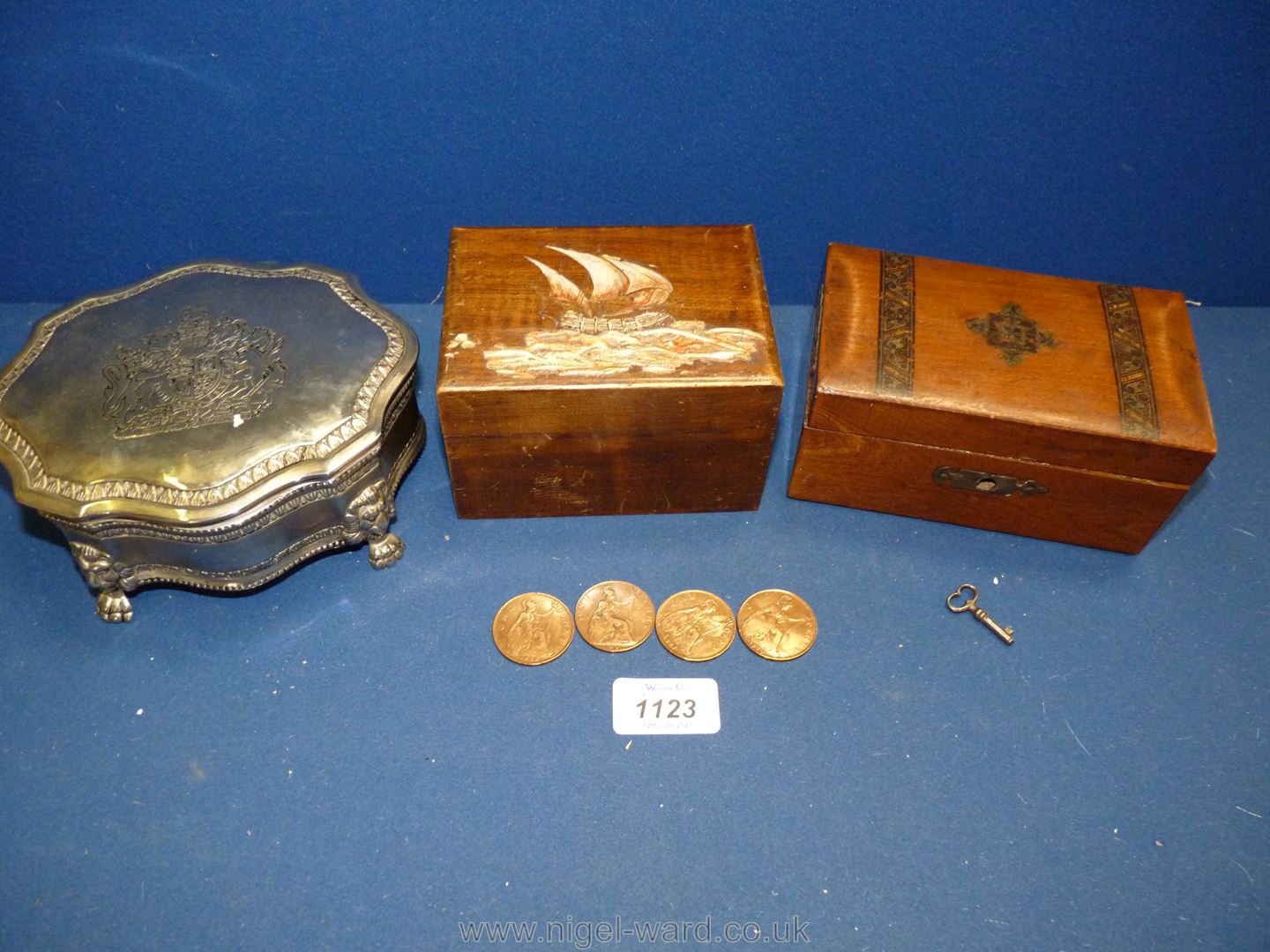 A white metal jewellery casket with crest on the lid and two wooden Boxes one with a few old