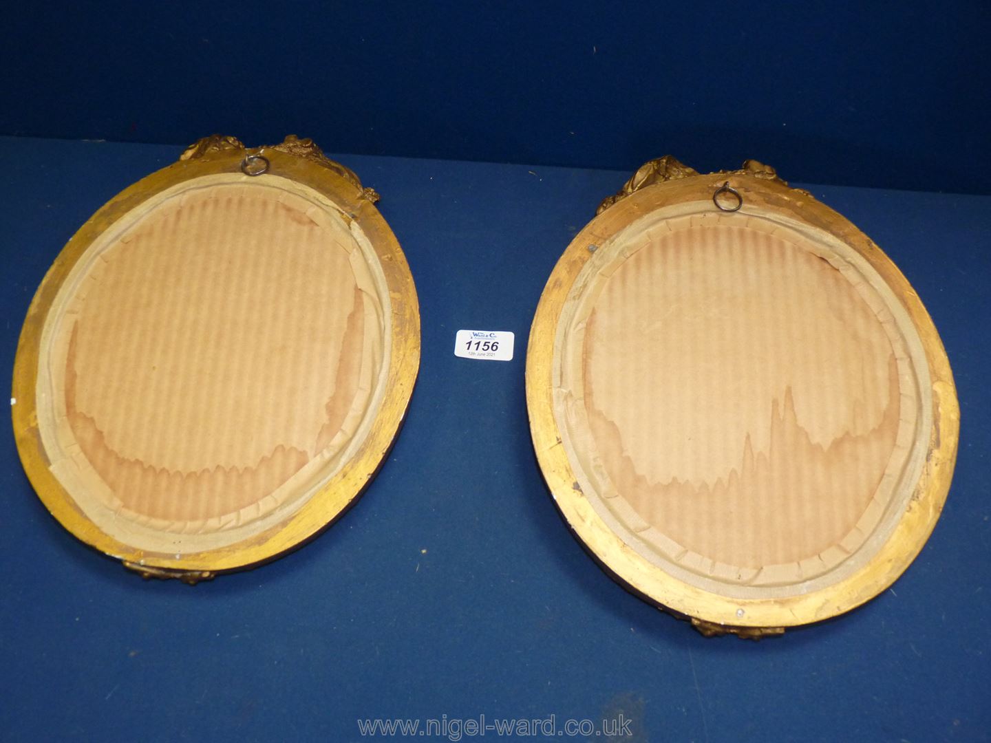 A pair of oval Mirrors in gilded frames with cherubs at the top and decorated with flowers and - Image 2 of 2