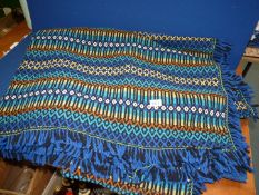 A large blue wool throw with fringing (some has come away).