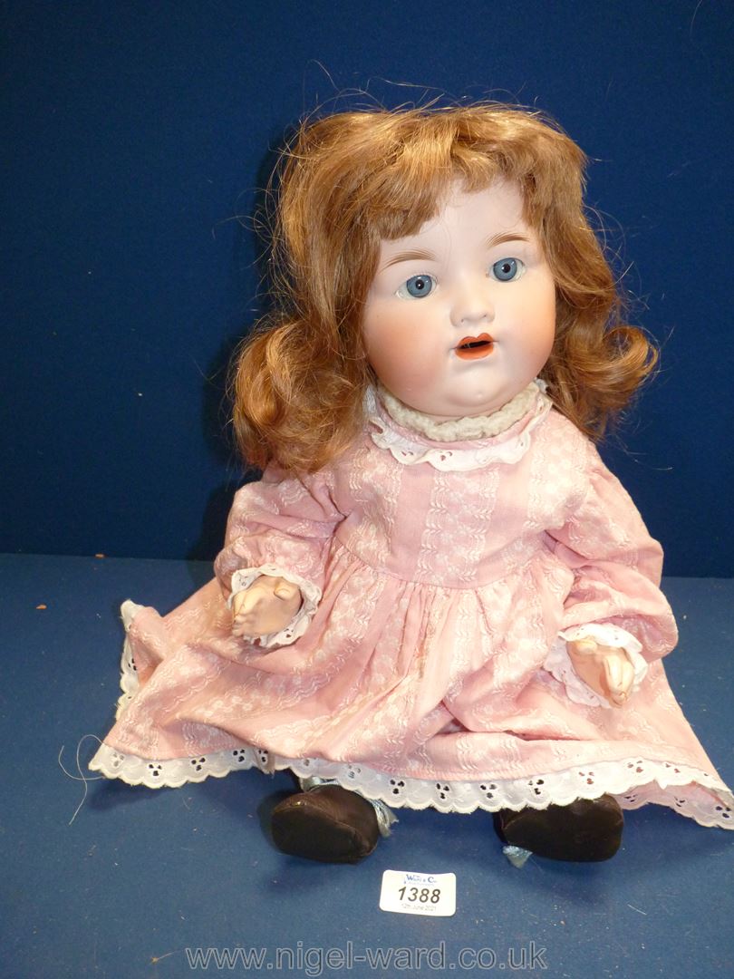 An Armand Marseille German doll, bisque headed, 990 A II M, 18" tall in pink dress and black shoes,