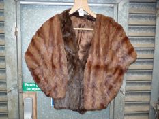 Two fur stoles in dark and light brown colour.