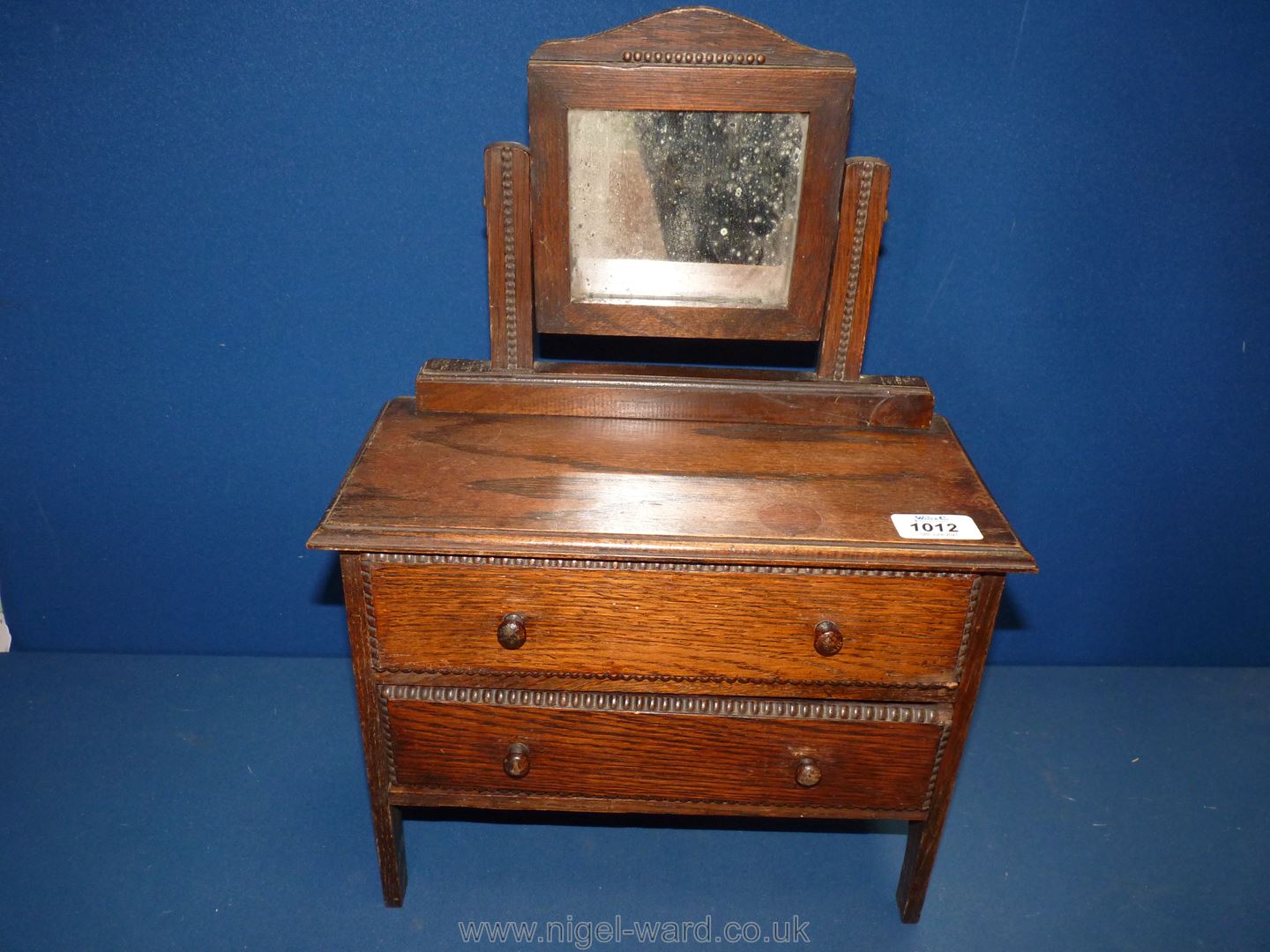 An Oak child's dressing table, circa 1920, 17 1/2" tall overall.