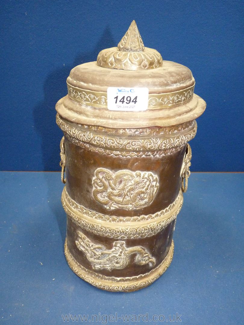 A brass and copper Tibetan scroll holder or canister for tobacco or tea, decorated with dragons,