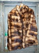 A blonde and brown hooded fur Jacket, size small, with pockets, lining a/f.