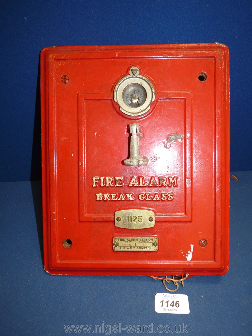 A red fire alarm panel 'Break Glass', no. 1125 from A.D.T Company.