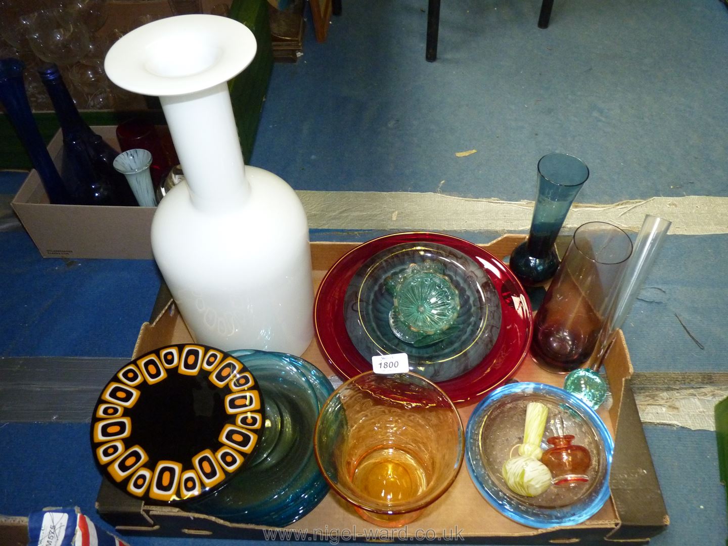 A quantity of coloured glass including large red bowl, three bud vases, orange perfume bottle etc.