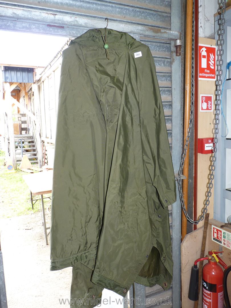 A large green waterproof hooded cape.