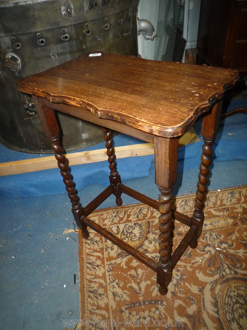 An Oak occasional Table having a shaped top and twist legs, 20'' x 13'' x 28'' high.