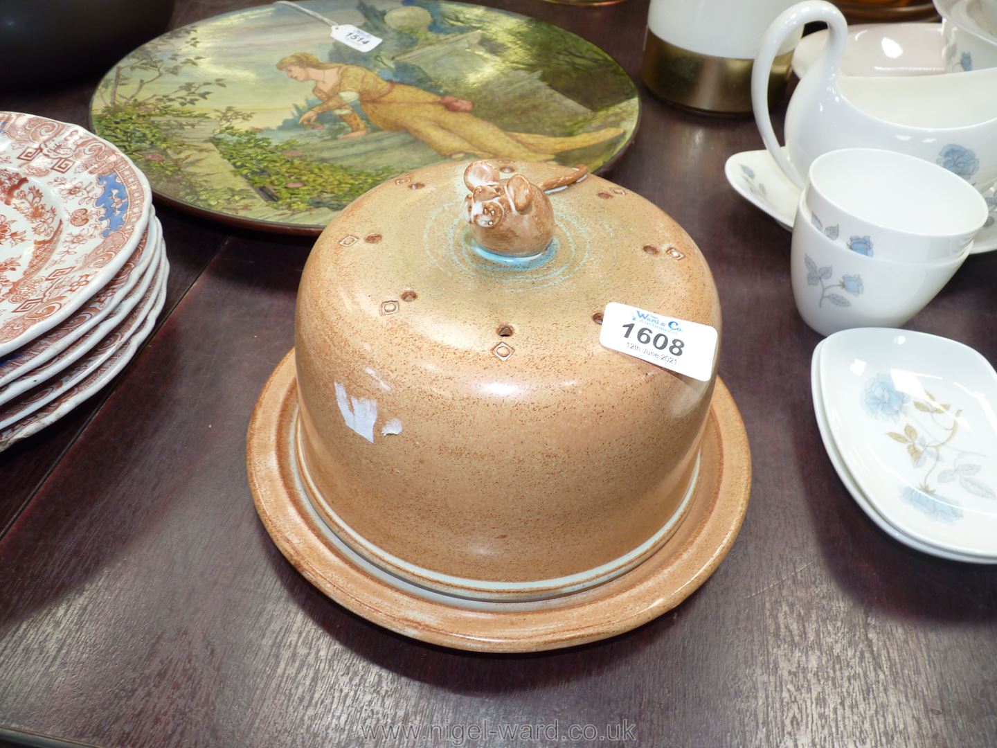 A Studio Pottery cheese dome with finial of mouse eating cheese.