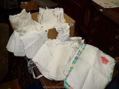 A quantity of vintage linen including tablecloths, napkins, place mats,