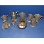 A quantity of Pewter tankards, candlestick and pot.