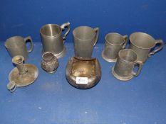 A quantity of Pewter tankards, candlestick and pot.