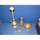 An Eastern brass hookah pipe, jug, bell and miniature coat scuttle.