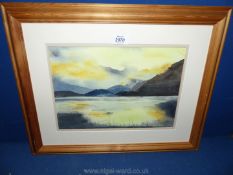 A framed and mounted Watercolour of a river scene at dusk, rolling hills in the distance,