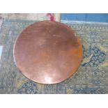A Copper covered table Top, 55 cms diameter, a/f.