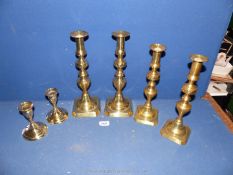 Three pairs of brass Candlesticks with pushers.